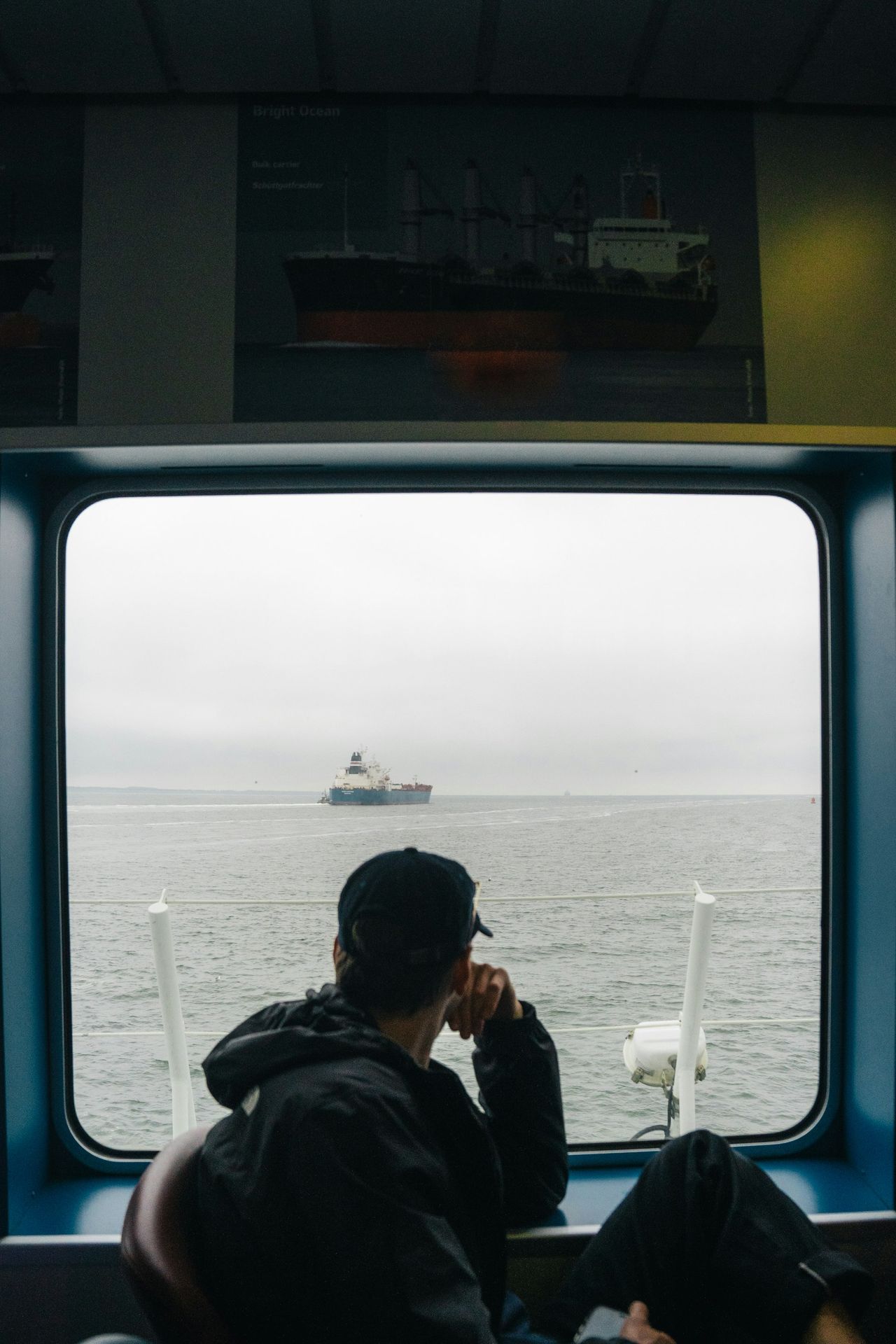 a man sitting on a train looking out the window